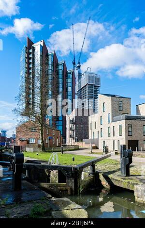 Islington Wharf, Islington Wharf Mews and Oxygen Tower (under construction) apartment blocks from the Ashton Canal, Ancoats, Manchester, England, UK Stock Photo