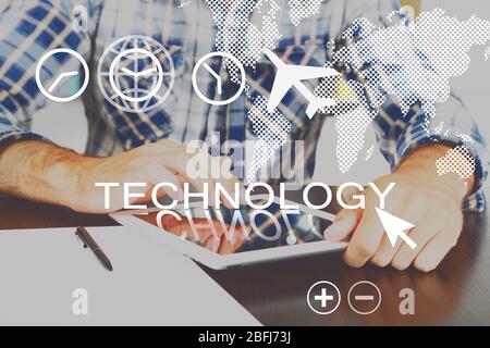 Young man using tablet pc with digital layer effect on background Stock Photo