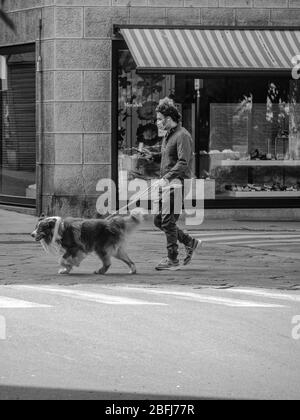 Cremona, Lombardy, Italy - April 19th 2020 - dog walking, everyday life during covid-19 lockdown outbreak Stock Photo