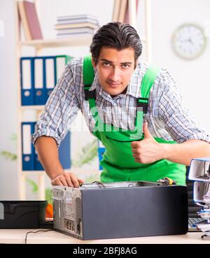 The young engineer repairing broken computer at the office Stock Photo