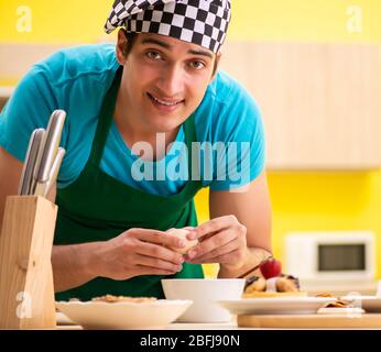 The man cook preparing cake in kitchen at home Stock Photo