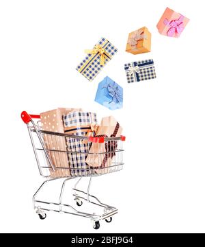 Gift boxes falling into cart isolated on white Stock Photo