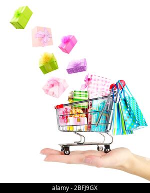 Gift boxes falling into cart isolated on white Stock Photo