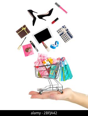 Goods falling into cart isolated on white Stock Photo