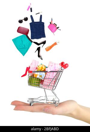 Goods falling into cart isolated on white Stock Photo