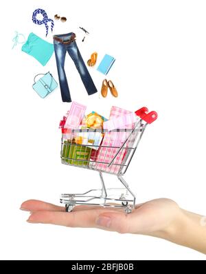 Goods falling into cart isolated on white Stock Photo