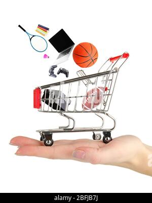 Goods falling into cart isolated on white Stock Photo