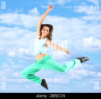 Jumping woman on sky background Stock Photo