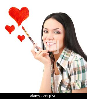 Beautiful young woman as painter with brush and red hearts isolated on white Stock Photo