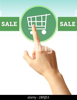 Female hand touching shopping cart symbol Stock Photo