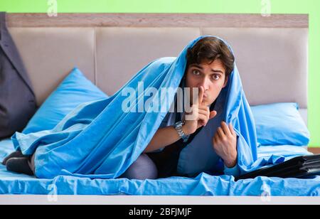 The employee in the bedroom being late for his job Stock Photo