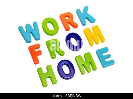 Coronavirus pandemic, text WORK FROM HOME on a white background. A call for people to work from home during the global pandemic. COVID-19 is the offic Stock Photo