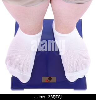 Fat man standing on electronic scales. Conceptual photo of weight loss. Stock Photo