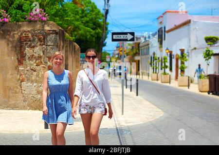 happy young girls, tourists walking on streets in city tour, Santo Domingo Stock Photo