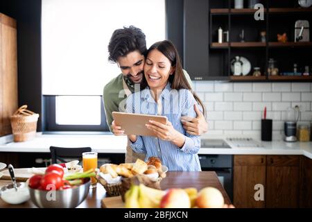 Beautiful couple in the kitchen while cooking. Stock Photo