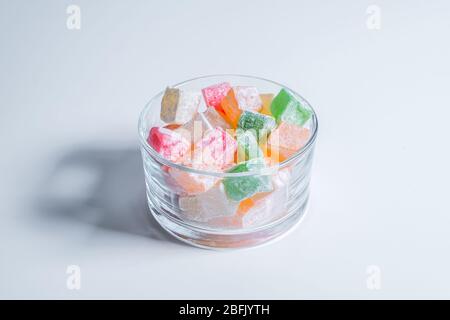 Turkish delights are in glass cup and on isolated white background Stock Photo