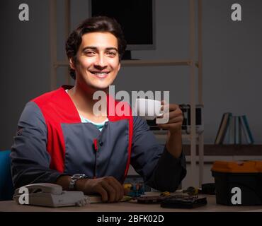 The young handsome repairman repairing computer Stock Photo