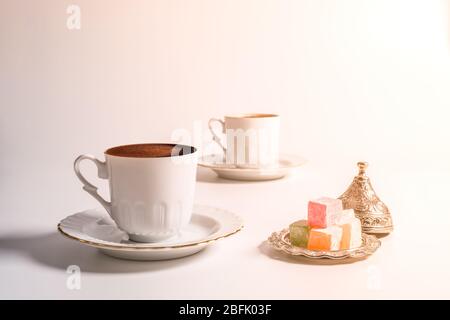 A cup of Turkish coffee in traditional white porcelain Turkish coffee cup Stock Photo