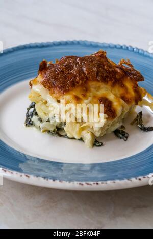 Baked Pasta Noodle with Bechamel Cheese Sauce and Spinach / Ziti Bolognese in Glass Bowl. Homemade Food. Stock Photo