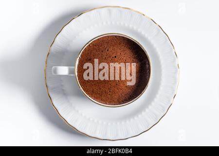 A cup of Turkish coffee in traditional white porcelain Turkish coffee cup Stock Photo