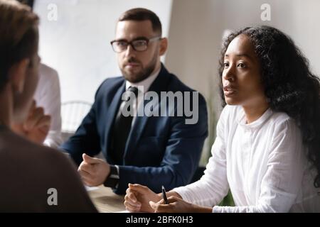 Multicultural businesspeople brainstorm cooperate at office briefing Stock Photo