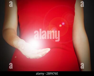 The light in young woman hand Stock Photo