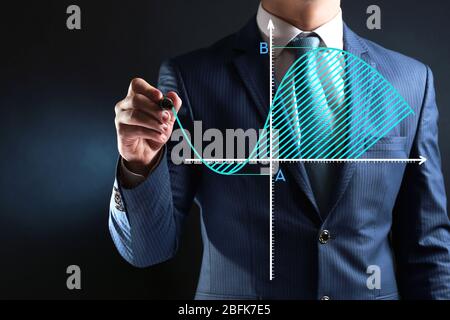 Businessman hand writing a business graph Stock Photo