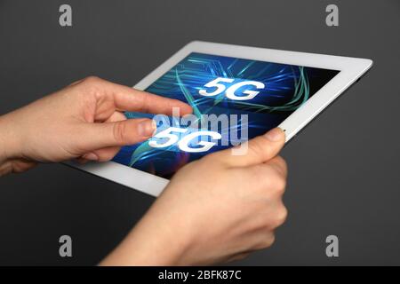 Woman use tablet PC on 5G high speed network communication internet. Stock Photo