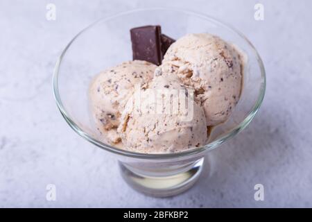 Homemade ice cream with chocolate chips in a bowl. Three balls of ice cream. Close-up. Stock Photo