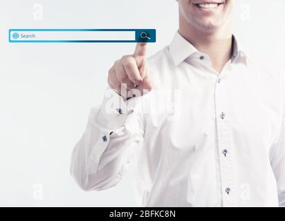 Searching system - businessman pressing search button Stock Photo