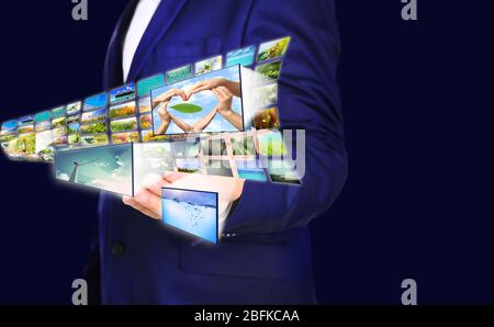 Businessman holding airplane of streaming images Stock Photo