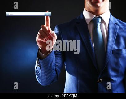 Searching system - businessman pressing search button Stock Photo