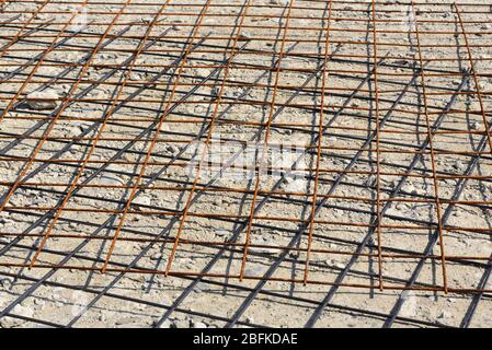 Background and texture of steel mats lying on the stony ground and partially rusted Stock Photo