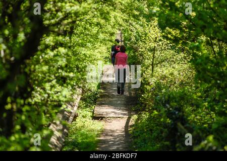 Underwood, Nottinghamshire, UK. April 19th, 2020. People out enjoying the sunshine while keeping social distancing and taking daily exercise. Stock Photo