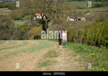 Underwood, Nottinghamshire, UK. April 19th, 2020. People out enjoying the sunshine while keeping social distancing and taking daily exercise. Stock Photo
