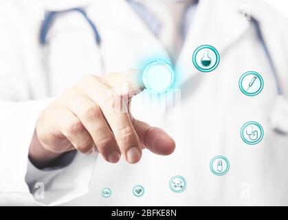 Doctor hand working with modern medical icons, close up Stock Photo