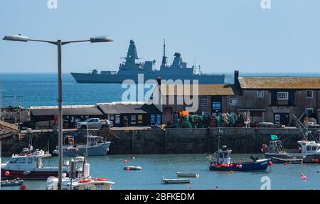 Lyme Regis, Dorset, UK. 19th Apr, 2020. UK Weather: Royal Navy Warship HMS Dauntless anchored at Lyme Regis on a warm and sunny afternoon during the coronavirus lockdown. Credit: Celia McMahon/Alamy Live News Stock Photo