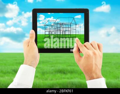 Architect showing new house project on tablet-pc, close up Stock Photo