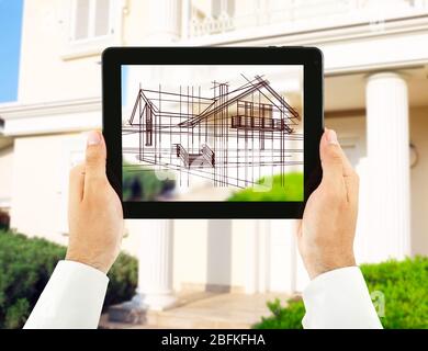Architect showing new house project on tablet-pc, close up Stock Photo