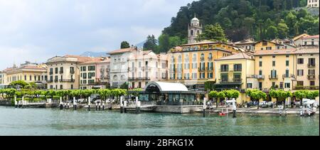 BELLAGIO, LAKE COMO, ITALY - JUNE 2019: Panoramic view of the lakefront and ferry landing stage at Bellagio on Lake Como. Stock Photo