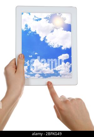 Hands holding tablet PC with sky in screen. Cloud computing concept Stock Photo