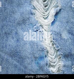 Denim jeans with old torn. Jeans torn denim texture. Denim jeans ripped destroyed Stock Photo