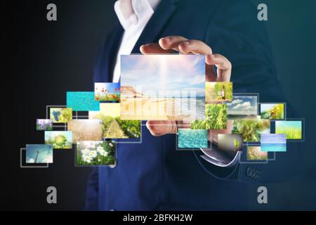 Businessman holding streaming images Stock Photo