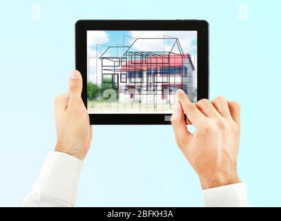 Architect showing new house project on tablet-pc, close up Stock Photo
