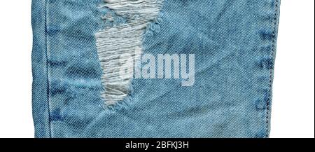 Denim jeans background with old torn.  Jeans torn denim texture. Denim jeans ripped destroyed. Hole and threads on denim jeans. Stock Photo