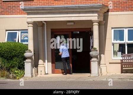 Care homes Brentwood Essex UK, winifred dell care home , Excelcare, , care assistant cleans entrance, Stock Photo