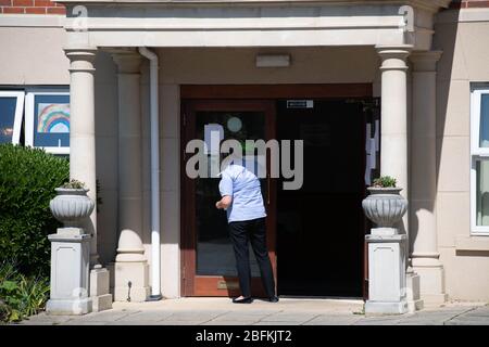 Care homes Brentwood Essex UK, winifred dell care home , Excelcare, , care assistant cleans entrance, Stock Photo