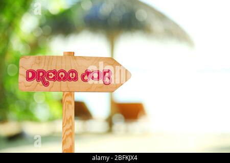 Dream job concept. Wooden sign arrow on nature background Stock Photo