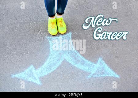 Dream job concept. Female feet and drawing arrows on pavement background Stock Photo