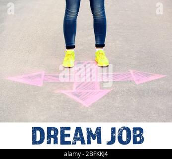 Dream job concept. Female feet and drawing arrow on pavement background Stock Photo